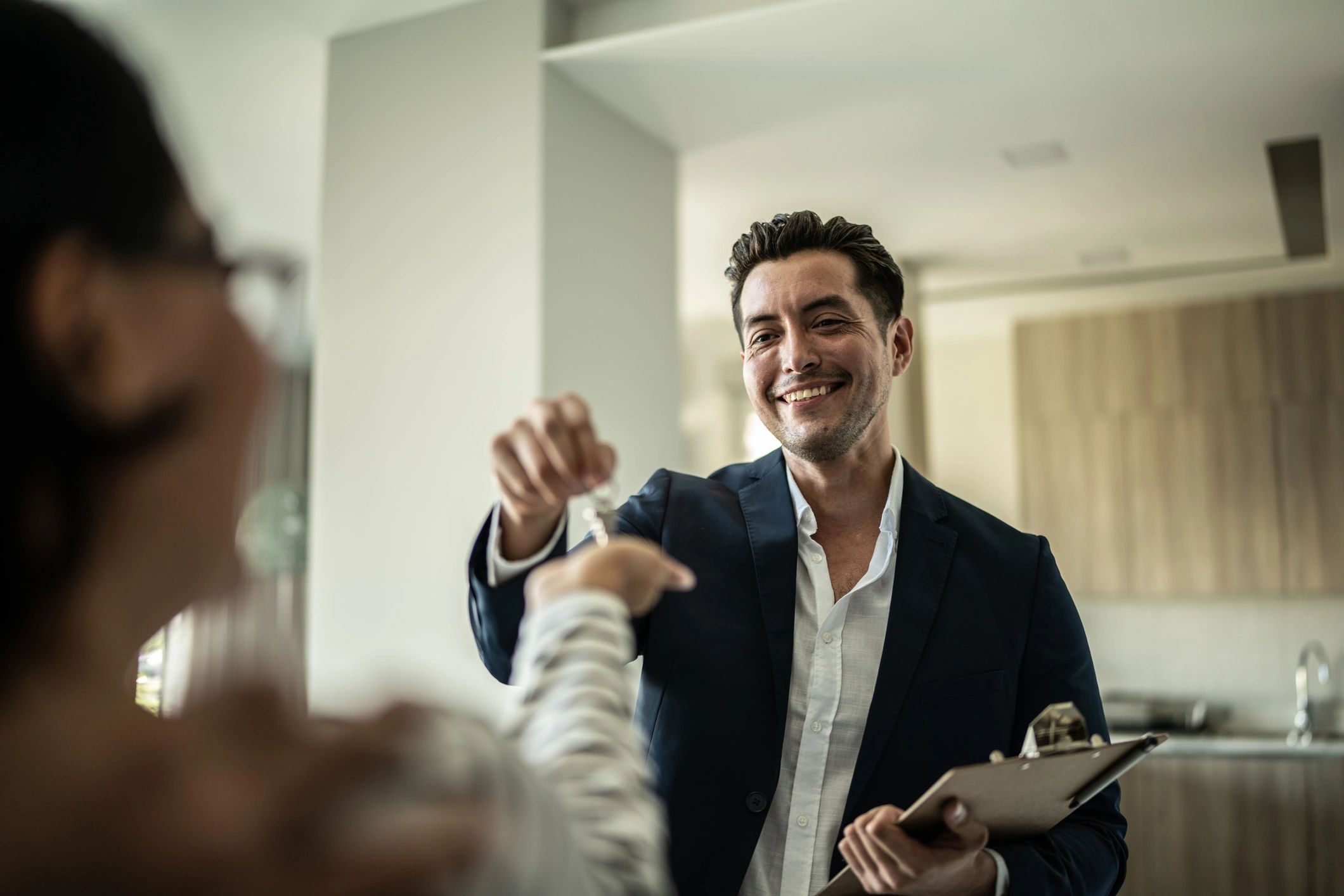 Real estate agent handing keys to a homebuyer