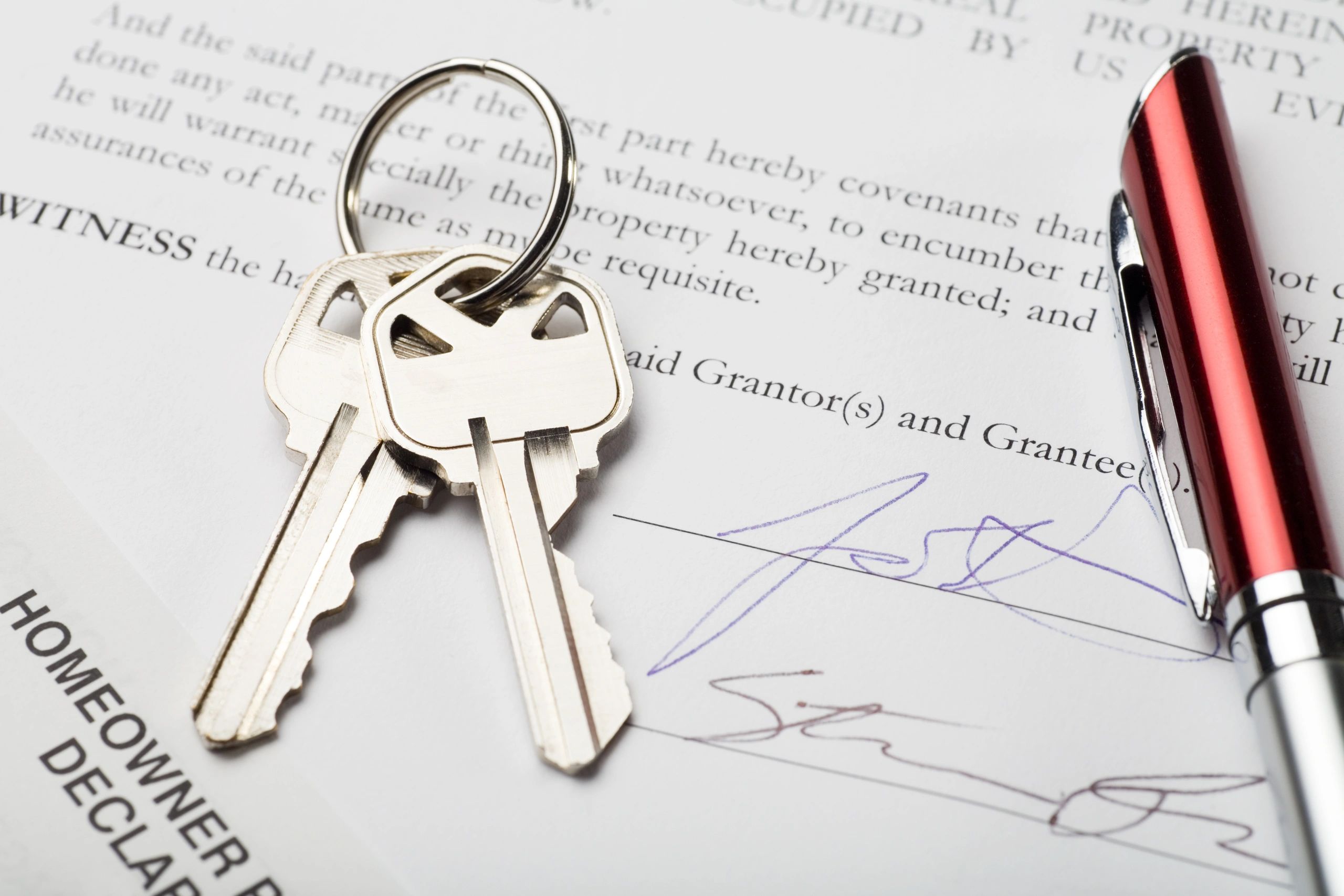 Signed home loan documents with keys